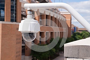 Video Security Camera Housing Mounted High on College Campus