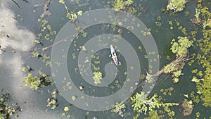 The video shows footage from a drone capturing a kayaker paddling in a serene