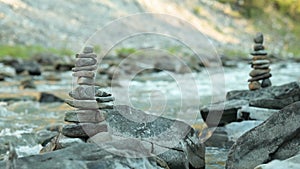 Video of small balanced stone towers on mountain river