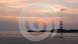 Video of small lighthouse against a tropical ocean sunset and smooth water at Khao Lak Beach in Phang Nga,Thailand.