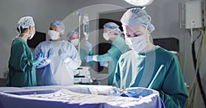 Video of smiling caucasian female surgeon checking instruments in operating theatre, copy space