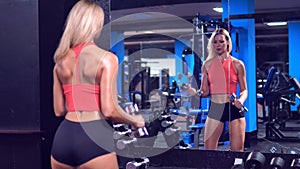 Video of sport woman hold dumbbell and training hard in the gym