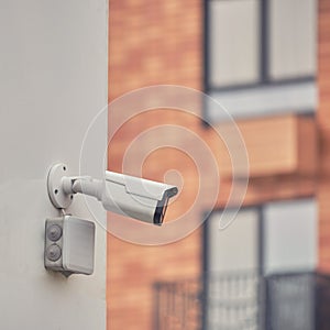 Video surveillance camera on the building, monitoring the security of a window residential house