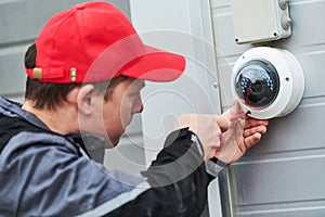 Video surveillance service. Technician installing camera