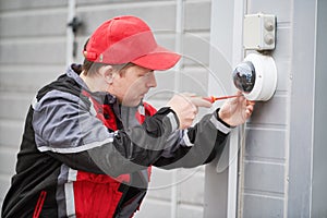 Video surveillance service. Technician installing camera