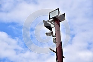 Video Surveillance. Video Camera on side post against a blue sky background. Security concept, forbidden territory, entry and