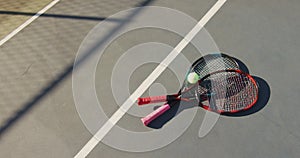 Video of tennis ball and rackets lying on tennis court