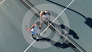 Video of top view of diverse female tennis players on court, shaking hands