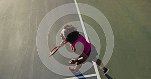 Video of top view of focused african american female tennis player holding racket and hitting ball