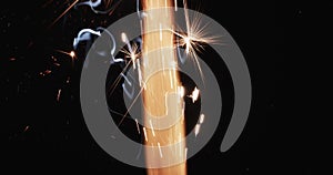 Video of torch with yellow flame and sparks and copy space on black background