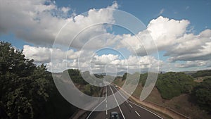 Video of traffic on the highway with cars and lights moving, seen from above, with a beautiful panorama of fields and mountains