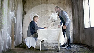 Video of two men in abandoned building, one of them screaming at other