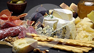 Video of various types of cheese and sausage - parmesan, brie, roquefort
