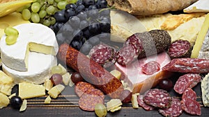 Video of various types of cheese and sausage - parmesan, brie, roquefort