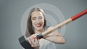 Video of young woman with sledgehammer