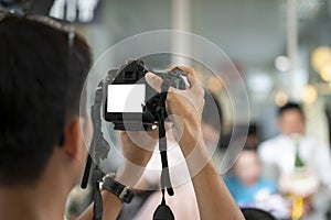 Videographer in the backside of camera are shooing and recording video in Wedding Event