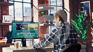 Videographer doing video montage using specialized software