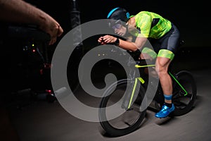 A videographer recording a triathlete riding his bike preparing for an upcoming marathon.Athlete& x27;s physical