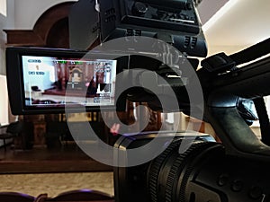 Videography in the interior. Digital video camera with LCD display. Led on-camera light