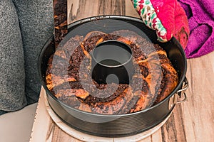 Vienna, Austria, April 24, 2020: Taking out the backed chocolate cake from the backing pan