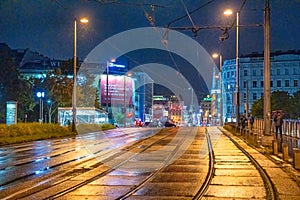 Vienna, Austria - August 22, 2022: City streets on a rainy night with tram railway