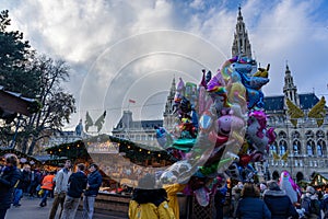 Vienna, Austria - 11.23.2019 : christkindelmarkt in Wien Vienna daytime with man people and balloons for the kids