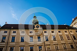 Vienna, Austria: Hofburg palace and panoramic square view, people walking and fiaker with white horses in Vienna, Austria