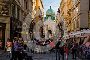 Vienna, Austria: Hofburg palace and panoramic square view, people walking and fiaker with white horses in Vienna, Austria