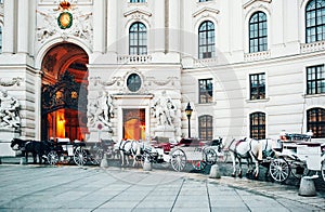 Vienna, Austria. Horse carriages by Hofburg Palace main entrance.