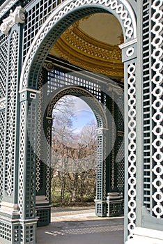 Vienna, Austria, March 2018. View of the garden through the arch of the old wooden arbor in the garden of Schonbrunn Palace, the