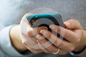 Vienna / Austria / November 14, 2020: Frontal view of womanâ€™s hands using the new smartphone with three cameras