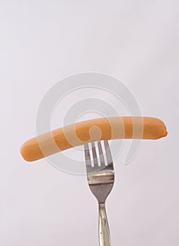 Vienna sausage on a metal fork