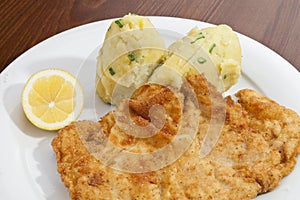 Vienna schnitzel with mashed potatoes and onion