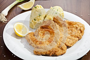 Vienna schnitzel with mashed potatoes and onion