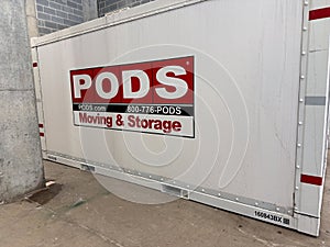 A PODS storage and moving container placed at a loading dock in an apartment building