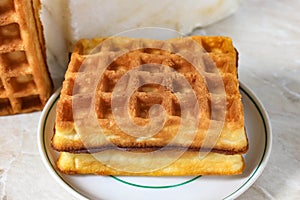 Viennese waffle with filling on a saucer close-up. Delicious dessert