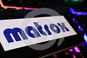 Closeup of smartphone on computer keyboard with logo lettering of Matrox electronic systems