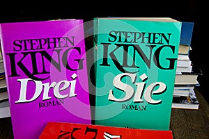 View on covers of Stephen King novels with pile of books background