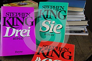 View on covers of Stephen King novels with pile of books background