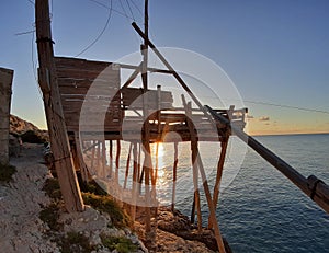 Vieste - Trabucco di Punta San Francesco in controluce all`alba photo
