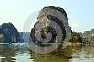 Limestone karsts with rowing boats  VÃÂ´ng ViÃÂªng Halong Bay Vietnam photo
