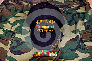 Vietnam Veteran Hat With Service Ribbons On Camouflage Uniform