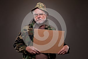 Vietnam Veteran holding a cardboard piece