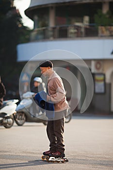 Vietnam, vietnamese man rides with roller skates