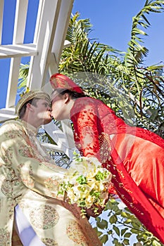 Vietnamese American wedding couple kiss