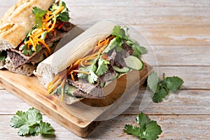 Vietnamese banh mi sandwich on wooden table