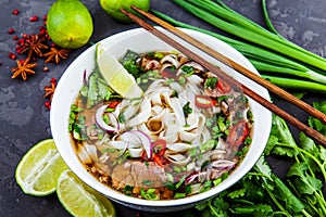 Vietnamese Beef Noodle Soup Pho Bo with beef on dark background