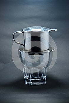 Vietnamese coffee drip on wooden planks with black background