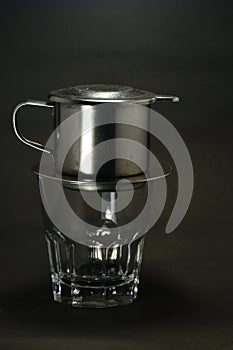 Vietnamese coffee drip on wooden planks with black background