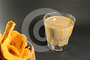 Vietnamese coffee drip on wooden planks with black background